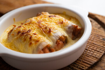 Meat cannelloni with bechamel sauce and gratin cheese. Traditional Spanish Christmas Tapa.
