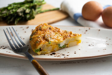 Spanish potato omelette with green asparagus. Traditional Spanish tapa recipe.