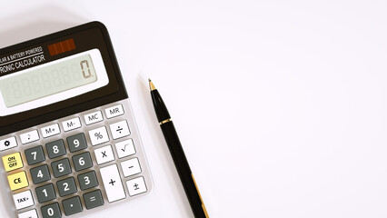 Electronic calculator and ball pen on white background. Business financial concept.