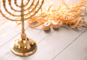 Banner of jewish holiday Hanukkah with wooden dreidels (spinning top) over glitter shiny background