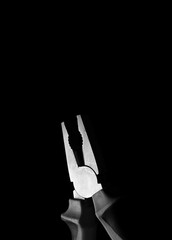 old pliers on black background
