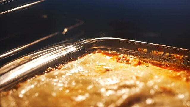 Italian lasagna baking in glass casserole.