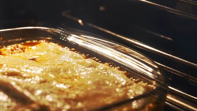 Italian lasagna baking in glass casserole.