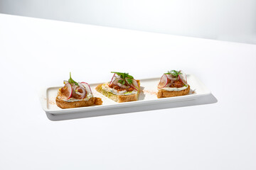 Aesthetic composition with tomato bruschetta on white background with harsh shadows. Italian bruschetta with tomatoes and cheese on fine dining in summer. Elegant menu concept.