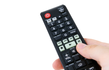 Hand holding remote control, isolated
