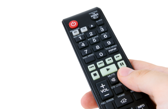 Hand holding remote control, isolated