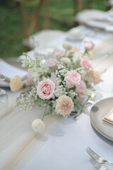 ideas for Wedding Decoration outdoors with white pink and orange flowers in the day light. Table Setting outdoors with flowers arrangement. Refreshing nature environment 