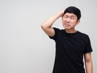 Young man black shirt hodld his head feels headache isolated