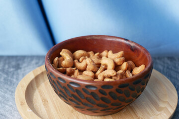 cashew nuts in a wooden bowl on table 