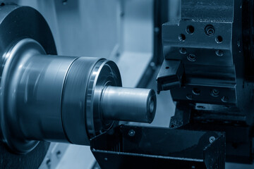 Fototapeta na wymiar The CNC lathe machine forming cutting the metal shaft parts.