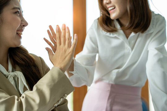 Close Up Female Hands Two Young Colleagues Happy About Their Project Give A Hi5 In Their Office