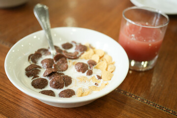 chocolate corn flakes in a bowl on table
