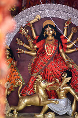 Idol of Goddess Devi Durga at a decorated puja pandal in Kolkata, West Bengal, India. Durga Puja is...