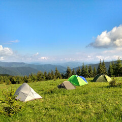 a tent on the slopes of high mountains, magical nature, endless sky
