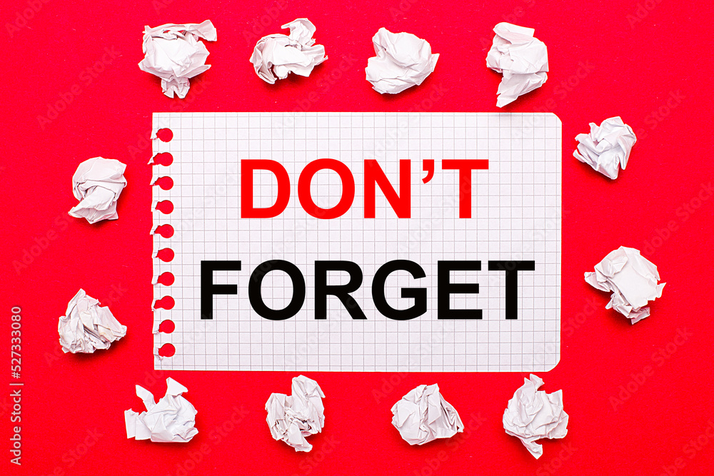 Poster on a bright red background, white crumpled sheets of paper and a sheet of paper with the text do not