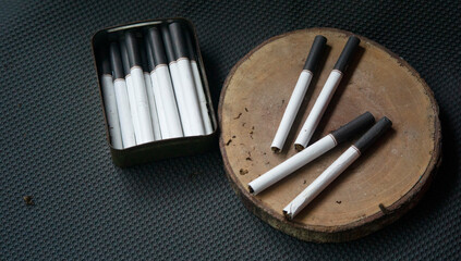 image of several commercially made cigarettes. pile cigarette on dark background. or Non smoking...