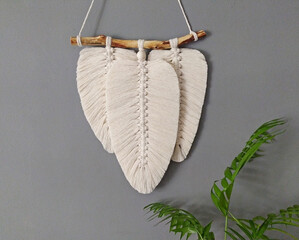 Macrame leaves in natural color. Cotton rope decor macrame to make your home more cozy and unique. Woman hobby. Copy space - obrazy, fototapety, plakaty