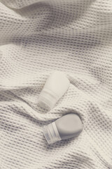 lotion tube mockup isolated on white fabric background.