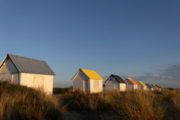 Fototapeta na wymiar Beach cabins in Gouville sur Mer, Manche, Normandy, France in various lights