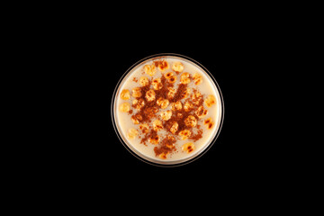 Boza or Bosa in disposable plastic take away cup on black background, top view. Turkish drink with roasted chickpea