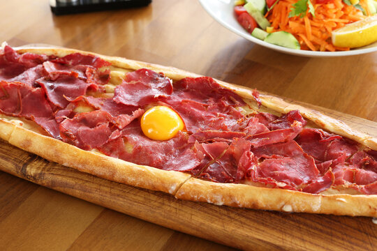 Traditional turkish baked dish pide with bacon. Turkish pizza pide