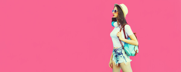 Summer colorful portrait of stylish modern young woman wearing straw hat, backpack and headphones walking on pink background, blank copy space for advertising text - Powered by Adobe