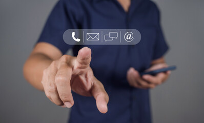 Man holding smart mobile phones and touching with call phone, email, chat message icons and address on virtual screen.