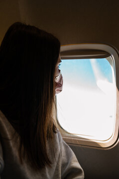 Female traveler looking out window