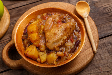 Chelnt in a plate on a wooden board on the table next to a wooden spoon.