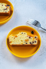 sliced homemade Apricot Blueberry pound cake on yellow plate..