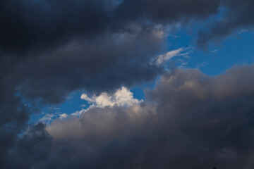 Dark cumulus clouds against a blue sky.