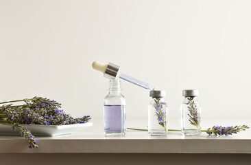 Vials with lavender essence preparation on laboratory bench white isolated