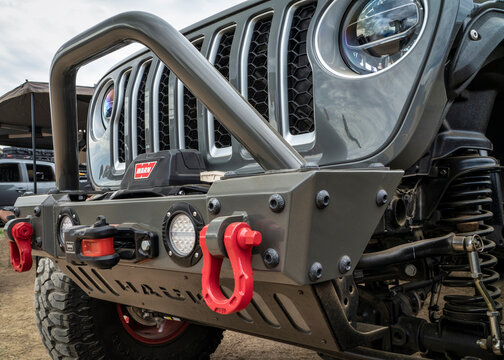 Front bumper with Warn winch and grille of Jeep Wrangler equipped for serious off-road driving.