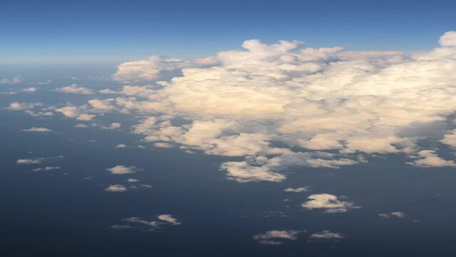 Aerial airplane view on the clouds, engine and Ryanair logo on the airplane wing. View from inside the plane on white clouds