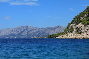 Fototapeta na wymiar Clean Adriatic Sea and mountain peaks in Croatia