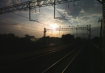 Fototapeta na wymiar Dramatic sunset on railway track transportation landscape
