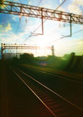 Fototapeta na wymiar Blurred light leak on railroad track backdrop