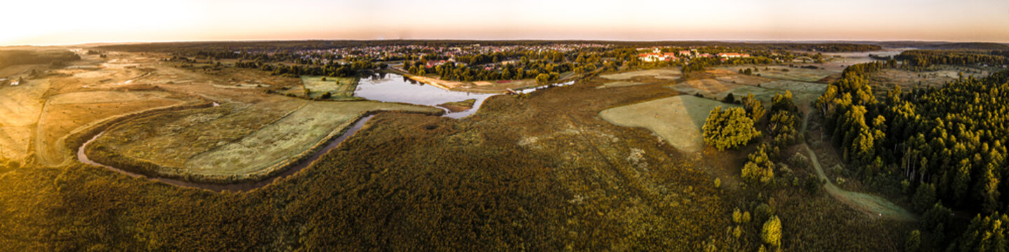 Panorama of the city of Suprasl at sunrise in the morning fog.