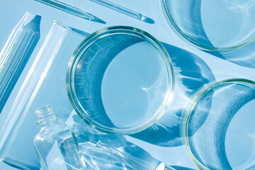 serum in petri dishes on light blue background cosmetic research concept	