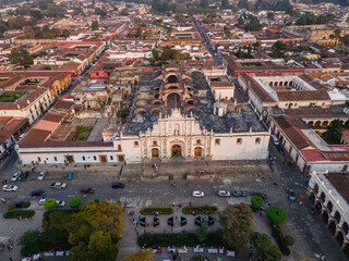 Beautiful aerial cinematic footage of the Antigua City in Guatemala, Its yellow church, the Santa Catalina Arch and the Acatenango Volcano