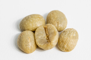 unroasted coffee beans on white background