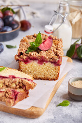 Pound cake with plums, cinnamon and streusel. Delicious autumn homemade dessert. 