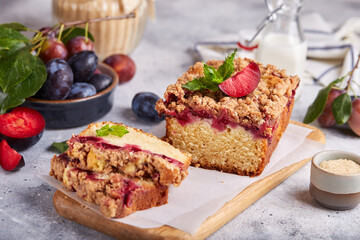 Pound cake with plums, cinnamon and streusel. Delicious autumn homemade dessert. 