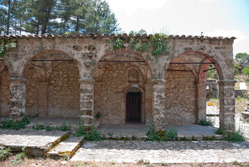 Naklejka premium Stemnitsa, Greece / July 2022: Historic traditional village at the slopes of Mainalon mountain in the Peloponnese. Medieval church.