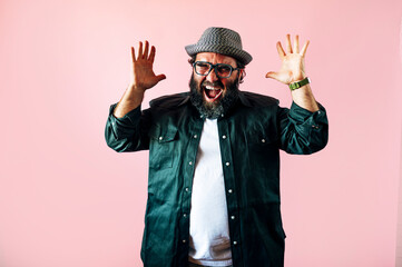 Fat man with a beard and raising his hands euphoric.