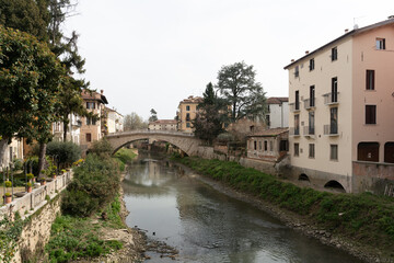 Fototapeta na wymiar View over the river (Fiume Retrone) in Vicenza (Italy) towards Ponte San Michele