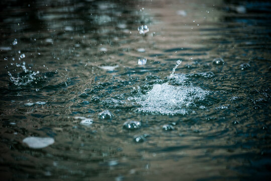 Closeup of water spashing in a public fountain in the street © pixarno