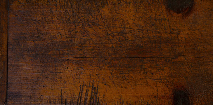 Close-up of worn antique cutting board with knife cut marks