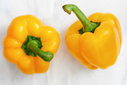Studio shot of two yellow bell peppers
