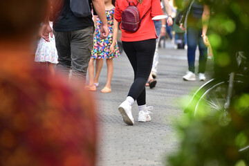 Street scene with many people walking